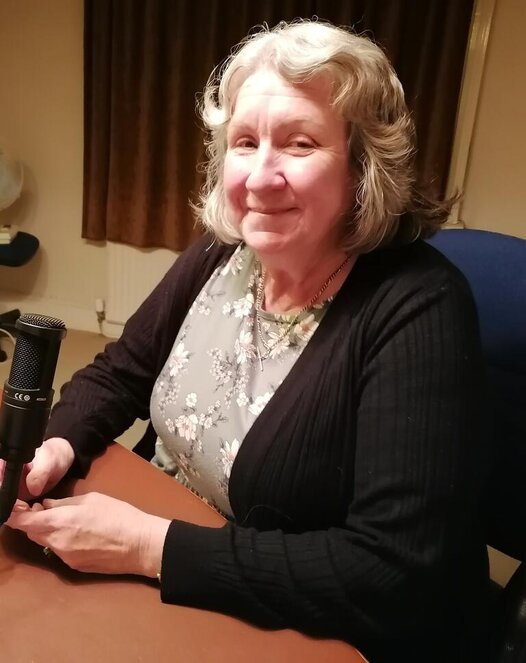 Picture of Mike Production and Volunteer Co-ordinator sat at the microphone