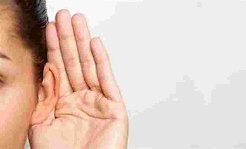 Picture of a person holding their hand to their ear