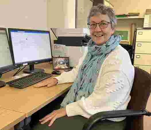 Picture of Ruth Volunteer working at the computer